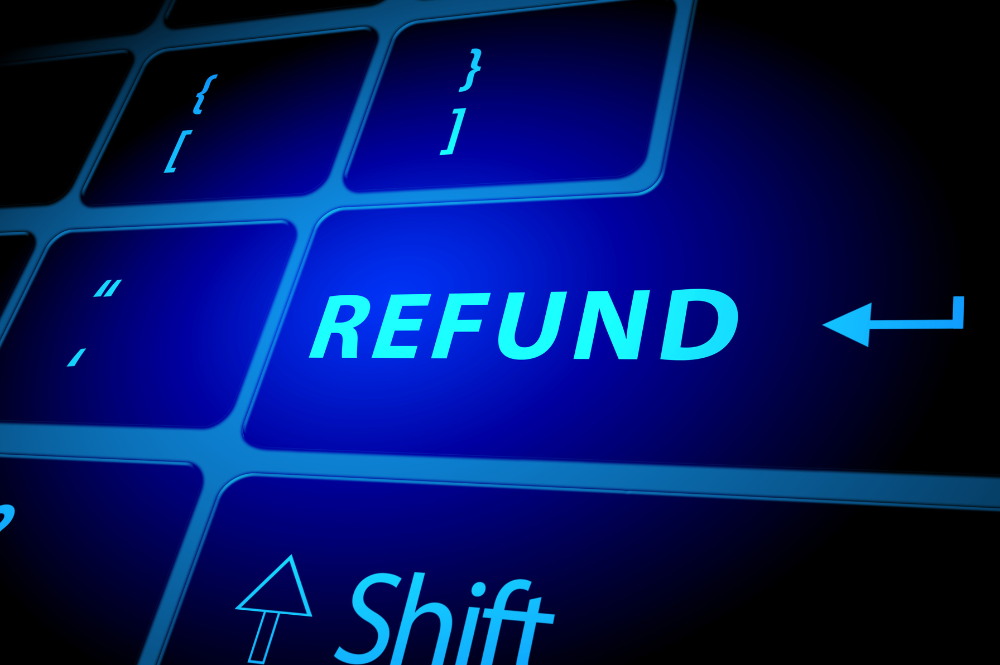 Glowing blue keyboard that has "REFUND" written on the return key. 